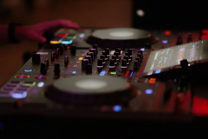 Close-up of a DJ controller glowing in blue and red light