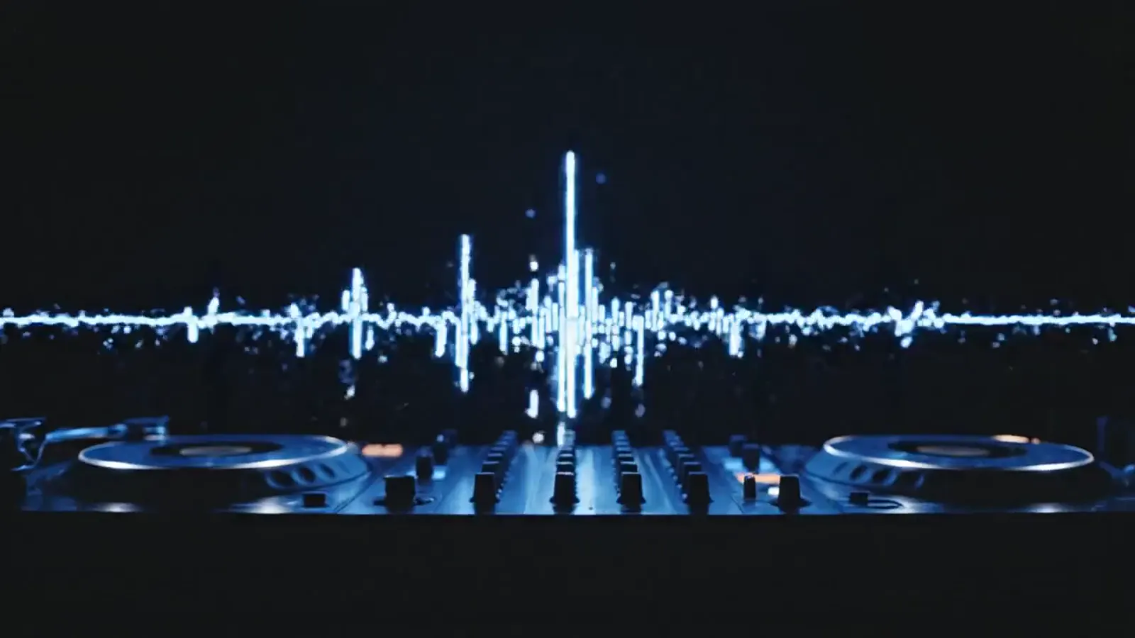 DJ mixer in blue haze with particles rising from the decks