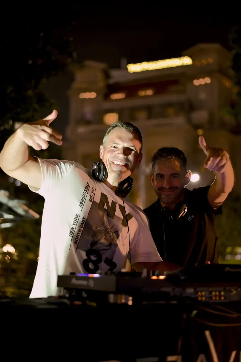 Driguo celebrating with a fellow DJ in the booth