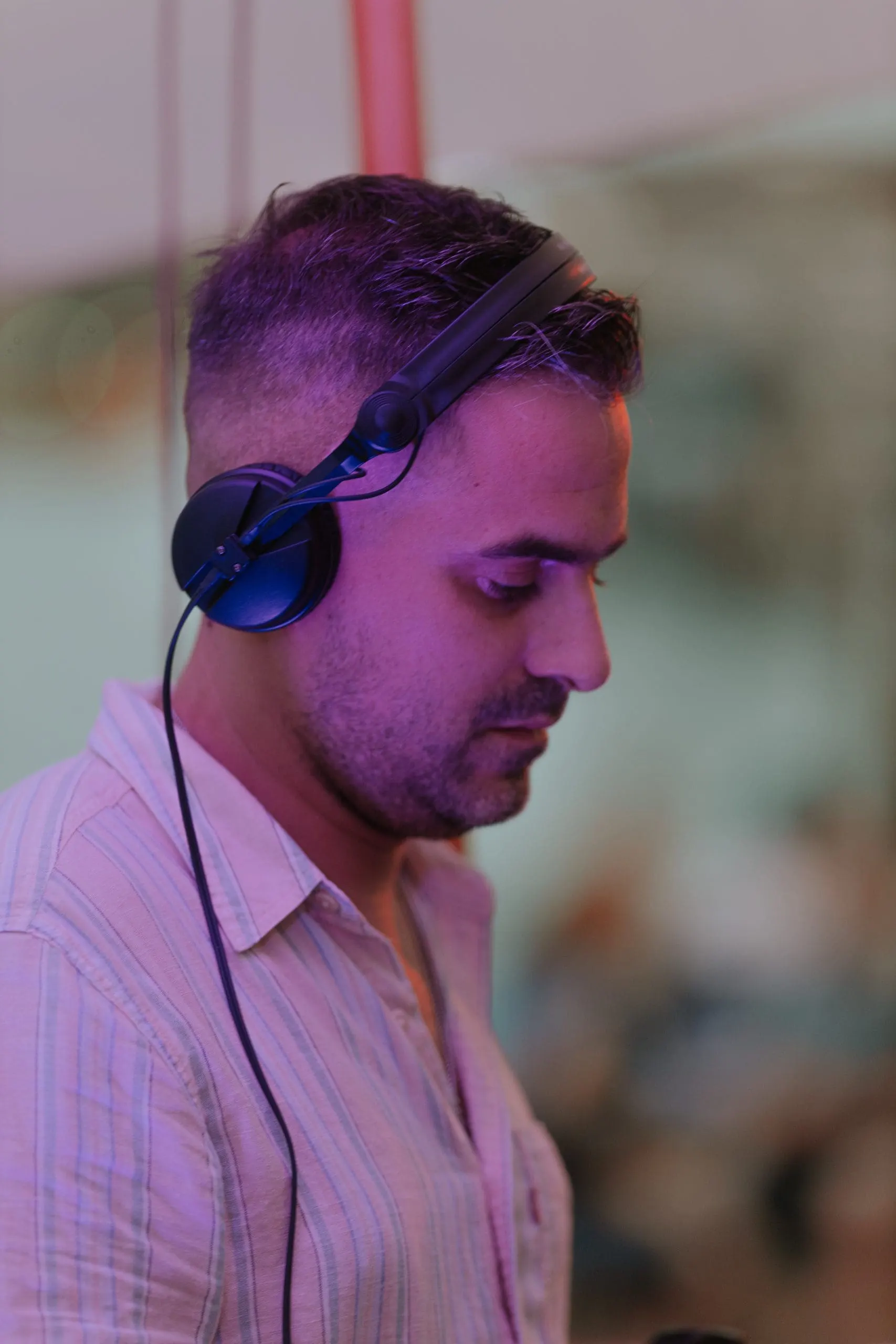 Portrait of Driguo wearing headphones at an evening event