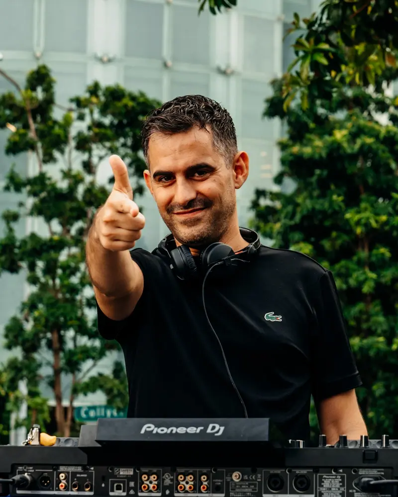 Driguo giving a thumbs up behind the decks on a rooftop