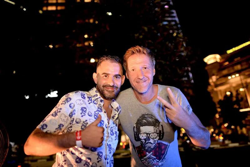 Driguo and a friend smiling together at a night event